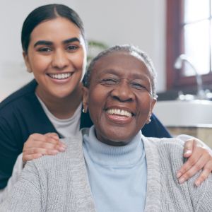 caregiver leaning over elderly woman in chair